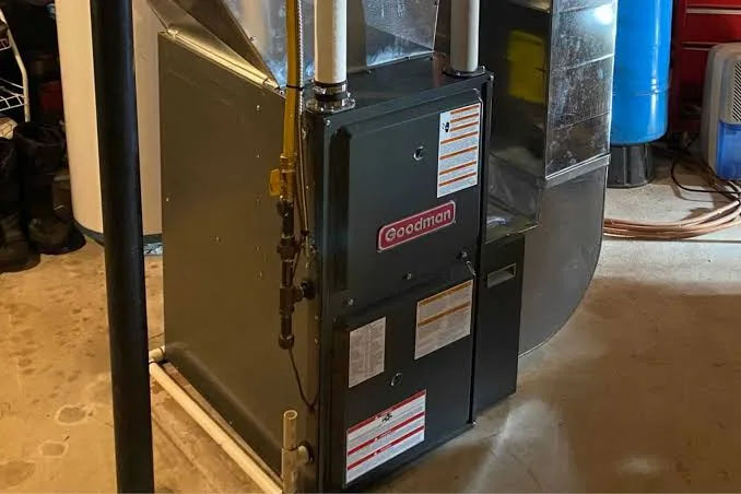 Residential gas furnace connected to ductwork in a mechanical room